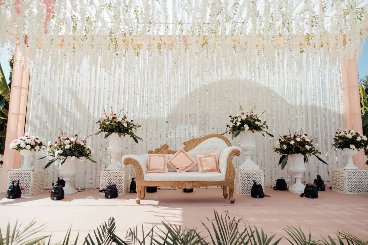 services-01 Luxurious outdoor wedding stage adorned with floral arrangements and elegant seating.